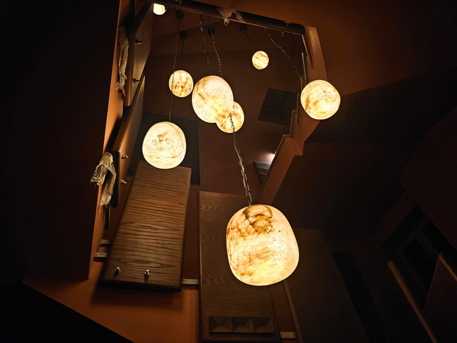 Low wide squat alabaster bedside lamp casting soft diffused gold illumination