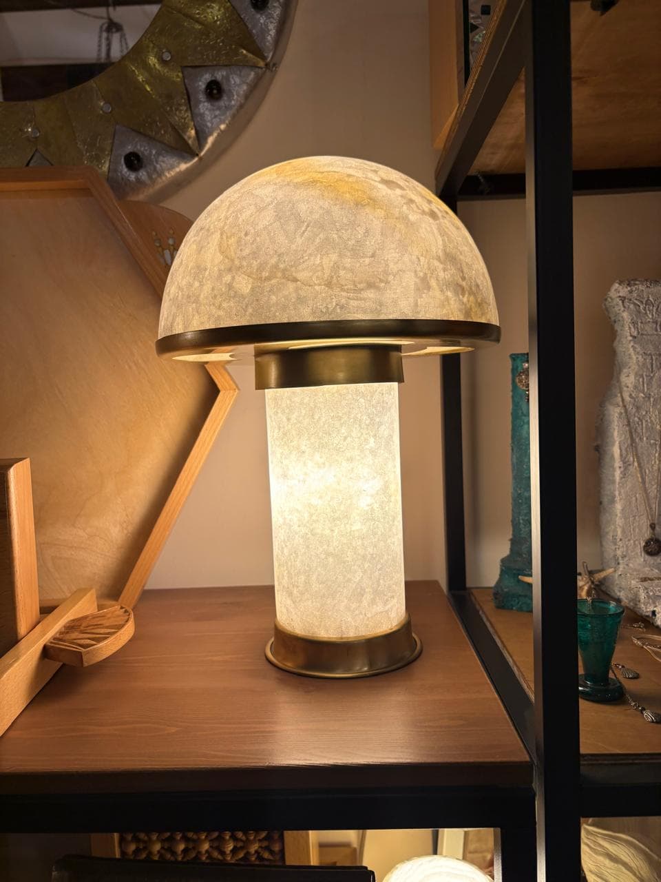 Low wide squat alabaster bedside lamp casting soft diffused gold illumination