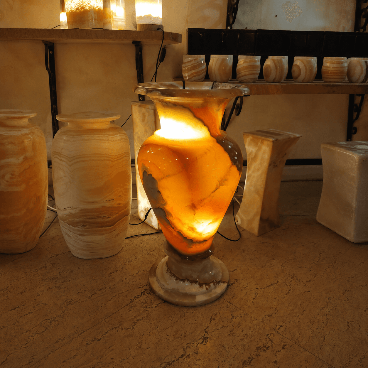 Round wide-belly carved alabaster decorative vase with warm gold tones